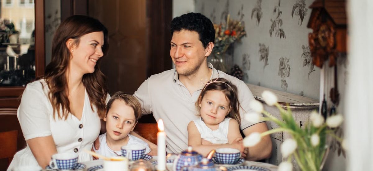 A warm family gathering celebrating a traditional Russian holiday indoors with festive food and decor.