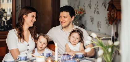 A warm family gathering celebrating a traditional Russian holiday indoors with festive food and decor.