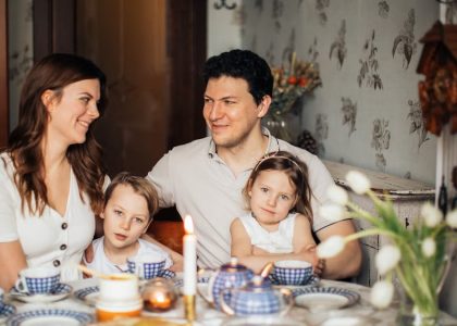A warm family gathering celebrating a traditional Russian holiday indoors with festive food and decor.